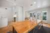 DINING AREA WITH LARGE TABLE NEXT TO BACK DECK ACCESS