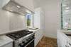 4 BURNER GAS STOVE AND LARGE CUSTOM BUILT IN FRIDGE