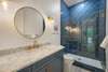 BATHROOM W/MARBLE SINGLE VANITY & GLASS ENCLOSED SHOWER