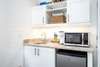 KITCHENETTE WITH MICROWAVE AND MINI FRIDGE IN PRIMARY BEDROOM