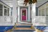 FUN PINK DOOR & TWO WELCOMING PORCHES FLANK FRONT OF HOME