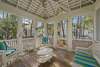SPACIOUS BACK PORCH WITH CUSHIONED OUTDOOR SEATING