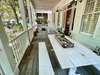 LARGE FRONT PORCH WITH SEATING AND OUTDOOR DINING