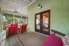 EXPANSIVE WRAP AROUND SCREENED IN FRONT PORCH