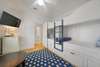 CUSTOM BUNK W/BUILT IN STORAGE & LARGE TV