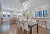 ADJACENT DINING AREA WITH STUNNING CHANDELIER SEATS 8