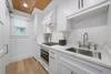 KITCHEN WITH STAINLESS STEEL APPLIANCES & QUARTZ COUNTERS KITCHEN WITH STAINLESS STEEL APPLIANCES & QUARTZ COUNTERS