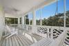 END STORY ENCLOSED PORCH W/BENCH SWING & ADIRONDACK SEATING END STORY ENCLOSED PORCH W/BENCH SWING & ADIRONDACK SEATING