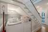 LAUNDRY NOOK UNDER ENTRANCE FOYER STAIRCASE