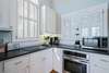 KITCHEN WITH ELECTRICAL STOVE TOP, KEURIG, AND COFFEE MAKER