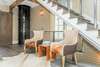 SEATING AREA BY STAIRCASE, NEAR BUTLER ELEVATOR