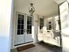 OPEN AIR PORCH W/BENCH SWING AT FRONT ENTRANCE OPEN AIR PORCH W/BENCH SWING AT FRONT ENTRANCE