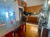 FULLY EQUIPPED KITCHEN AND DINING AREA ON SECOND LEVEL