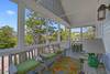 FURNISHED BALCONY WITH SEATING, DINING, AND SWING FURNISHED BALCONY WITH SEATING, DINING, AND SWING