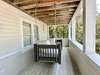 LARGE WRAP AROUND PORCH WITH BED SWING