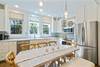 LARGE CHANDELIERS, ALL STAINLESS APPLIANCES IN MODERN KITCHEN LARGE CHANDELIERS, ALL STAINLESS APPLIANCES IN MODERN KITCHEN