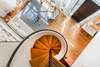 VIEW OF SPACIOUS MAIN LEVEL FROM TOP OF SPIRAL STAIRCASE