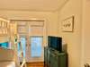 BUNK ROOM WITH FLATSCREEN, DRESSER, AND BALCONY ACCESS