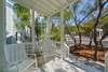 FRONT PORCH WITH ROCKERS & FENCED YARD