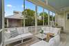 LARGE PORCH WITH CUSHIONED, OUTDOOR SEATING FOR ALL