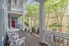 EXPANSIVE DOWN PORCH RUNS LENGTH OF HOME
