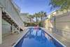 Patio and pool with privacy fence, perfect for entertaining