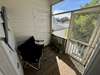 Front of beach house with screened in deck.