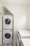 Laundry room with two sets of washers and dryers