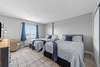 Bedroom with two queen beds with balcony overlooking marina