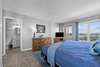 Bedroom with attached full bath with balcony overlooking the marina and ocean views from the windows