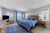 Bedroom with attached full bath with balcony overlooking the marina and ocean views from the windows