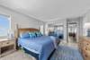 Bedroom with attached full bath with balcony overlooking the marina and ocean views from the windows