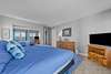 Bedroom with attached full bath with balcony overlooking the marina and ocean views from the windows