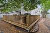 Spacious backyard deck with gas grill and ample seating