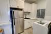 Laundry room with backup fridge