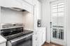 Kitchen side door which exits to the parking area behind the home and the outdoor shower