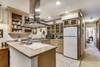 Roomy fully equipped kitchen and view towards queen bedroom and bath entrance