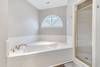 Master bath with shower and soaking tub.