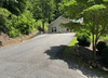 The driveway leading to the home is steep but paved. Parking is available for up to 3 cars.