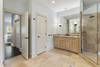 Master bathroom with soaking tub, shower with double heads, and two vanities.