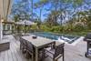 Stunning pool with dining area, grill, and lounge seating.