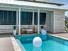 Cabana with lounge area, bathroom stall and outdoor shower stall.