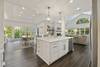 View of kitchen, living and dining spaces showing open-concept.