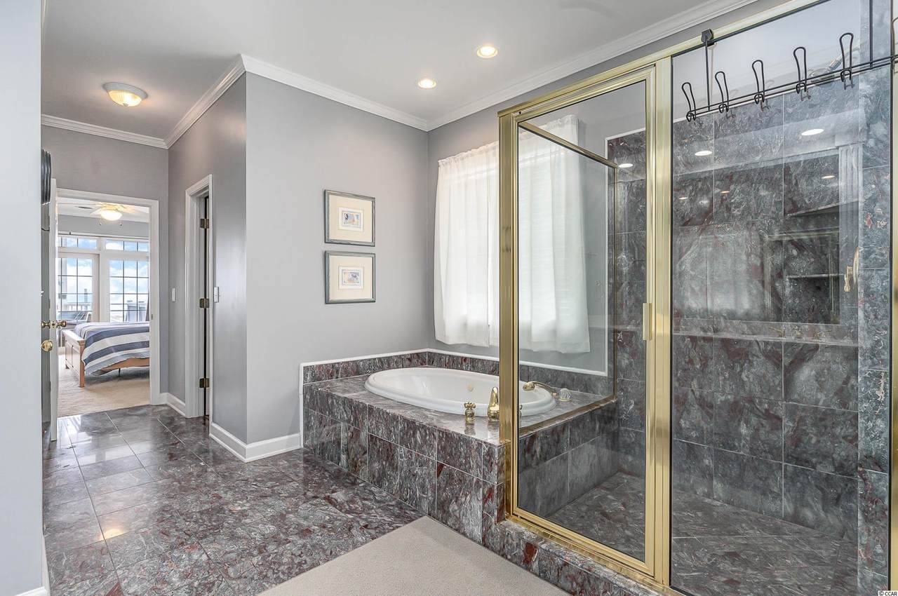 Bedroom 1 Bathroom features a tub and walk-in shower. Bedroom 1 Bathroom features a tub and walk-in shower.