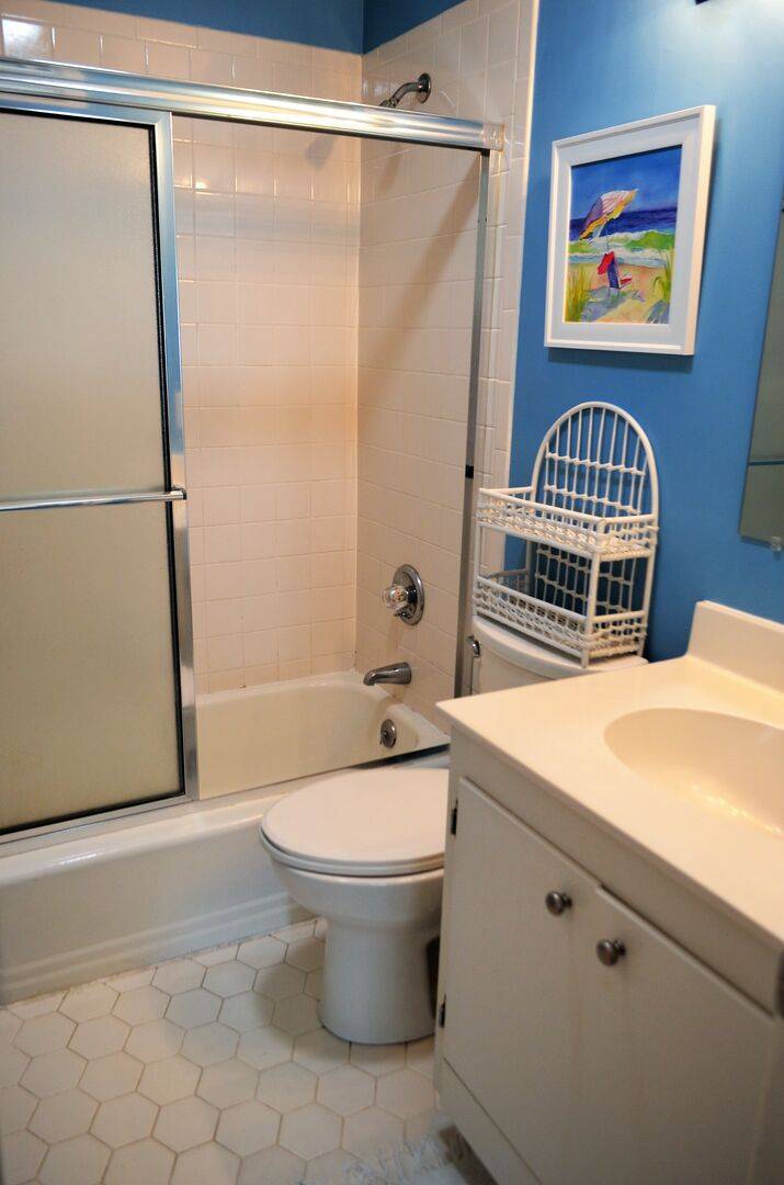 Cottage 1: Hall Bathroom (remodel in progress Fall 2023) Will be a walk-in shower and no longer have a tub. New photos coming soon. Cottage 1: Hall Bathroom (remodel in progress Fall 2023) Will be a walk-in shower and no longer have a tub. New photos coming soon.