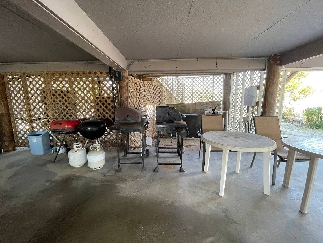 Picnic tables and grills (propane and charcoal) under the house Picnic tables and grills (propane and charcoal) under the house