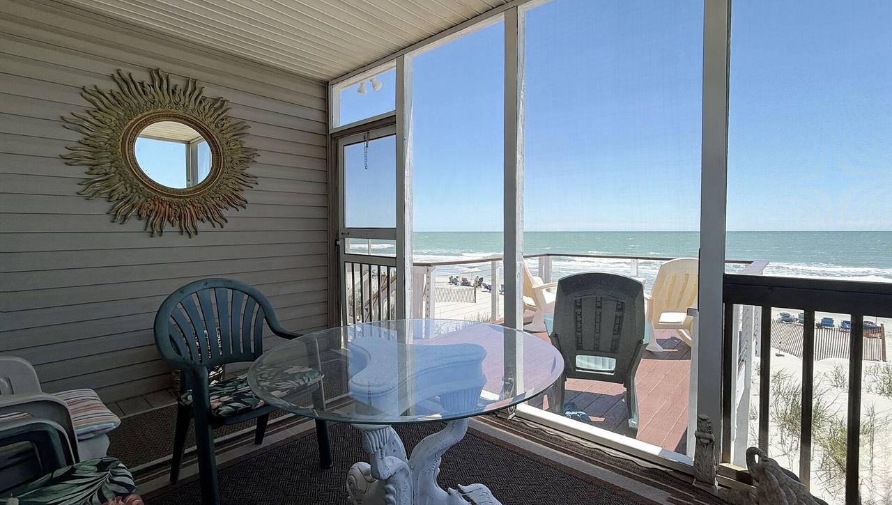 Step out onto the screened-in porch. Step out onto the screened-in porch.