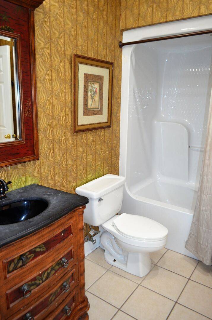 Bathroom 1 features a single vanity & shower/tub combo. Bathroom 1 features a single vanity & shower/tub combo.
