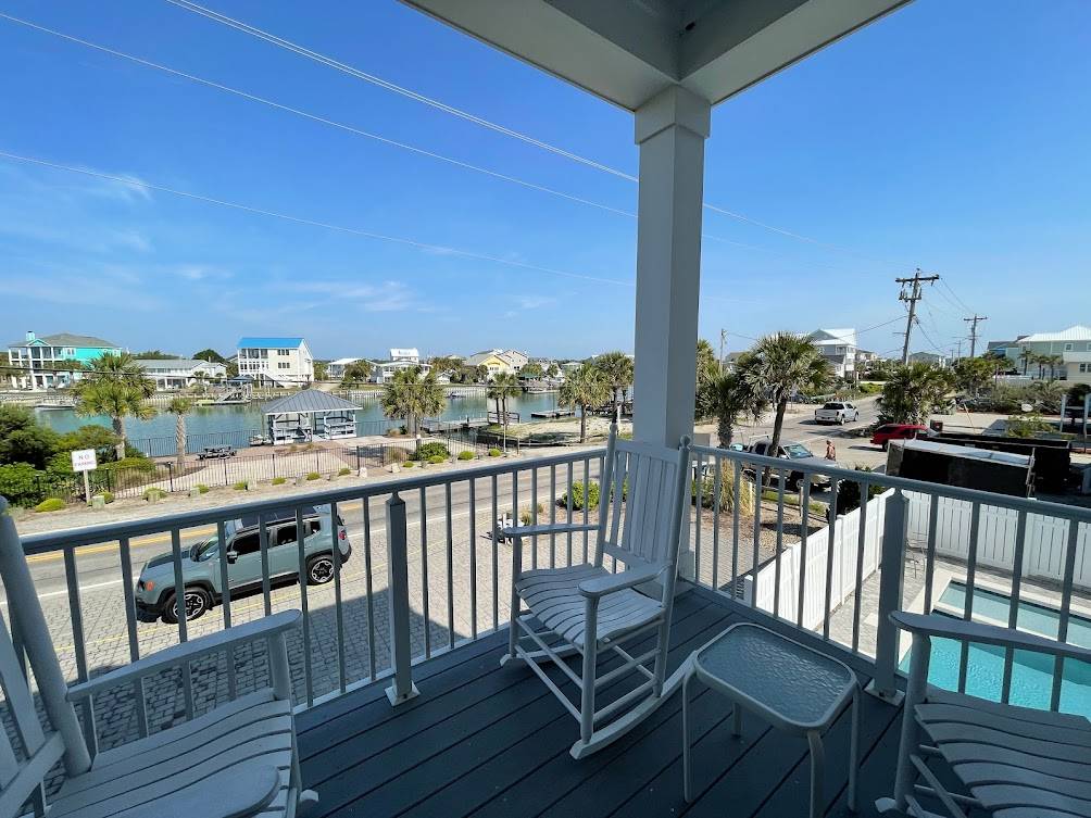 Oyster Cove and pool view from the street side porch. Oyster Cove and pool view from the street side porch.