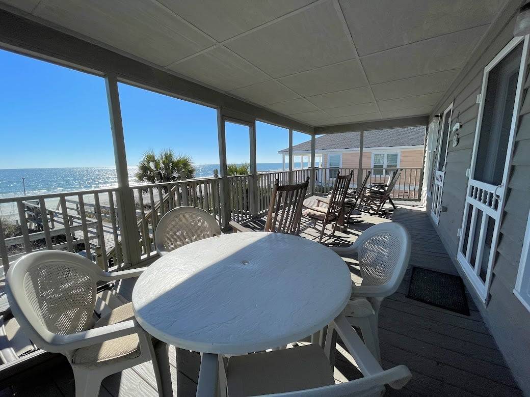 Relax and dine on the ocean front covered porch. Relax and dine on the ocean front covered porch.